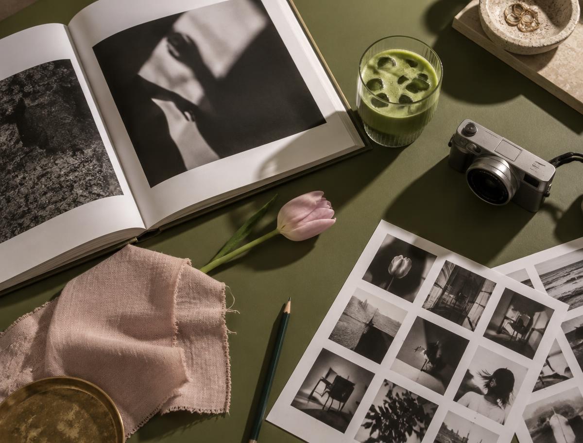 Content planning desk with camera, editorial moodboard and iced matcha